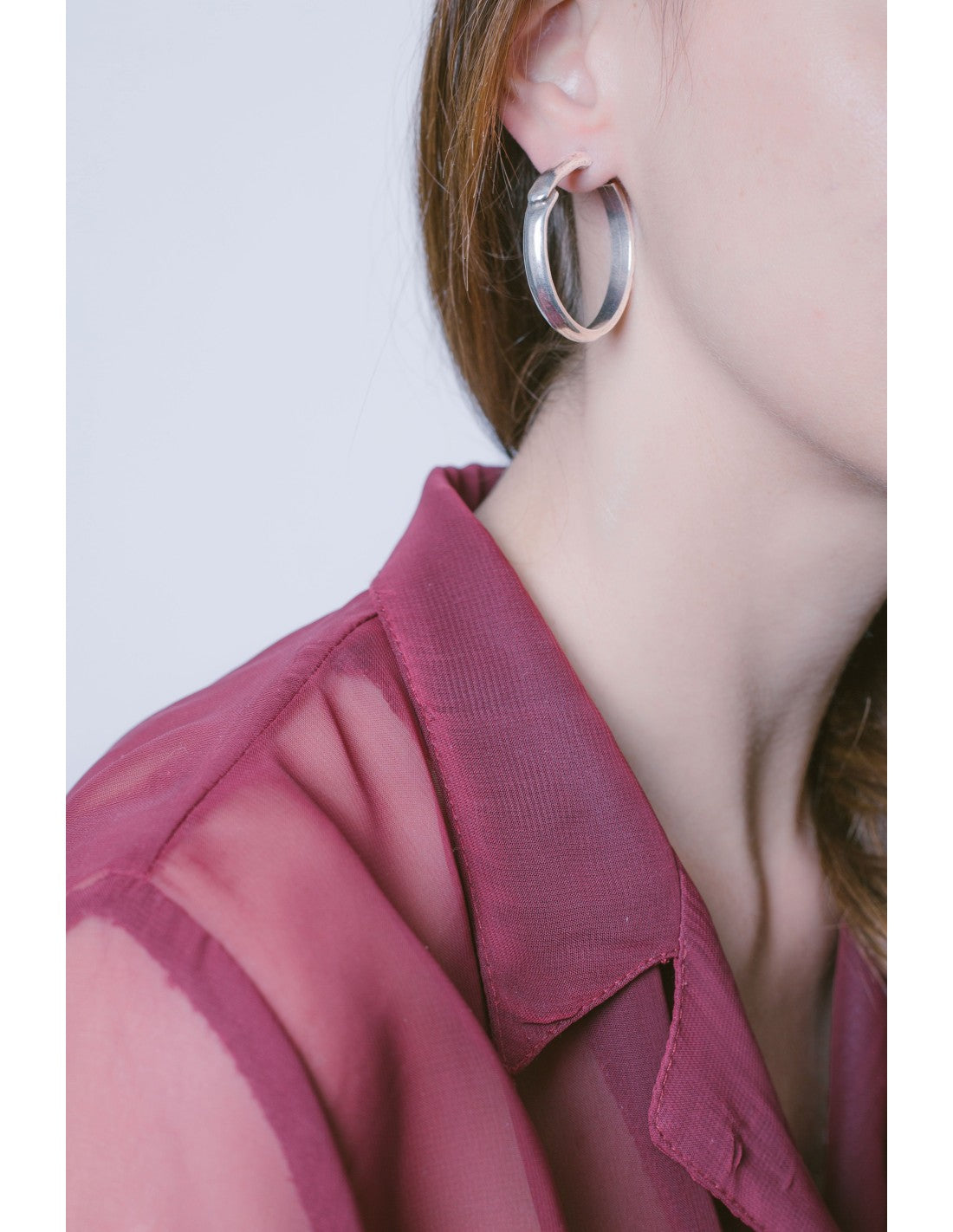 woman wearing silver hoop earrings