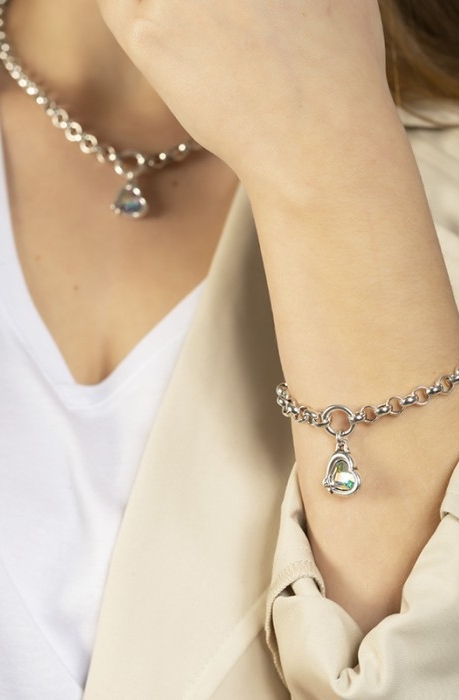 woman wearing silver link bracelet with multicolor heart-shaped pendant charm