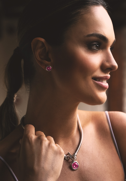 woman wearing silver earrings accented with a square-shaped rose faceted stone