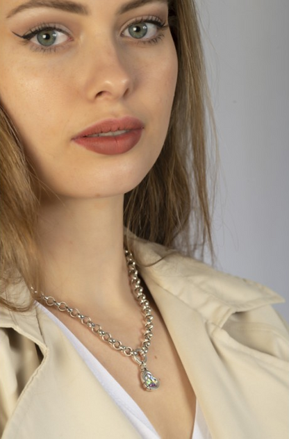 woman wearing a women's silver necklace with charm pendant and a heart wrapped in cupid's arrow