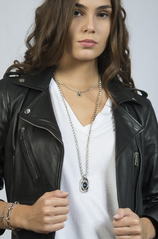 woman wearing long silver necklace with silver and blue murano glass pendant 