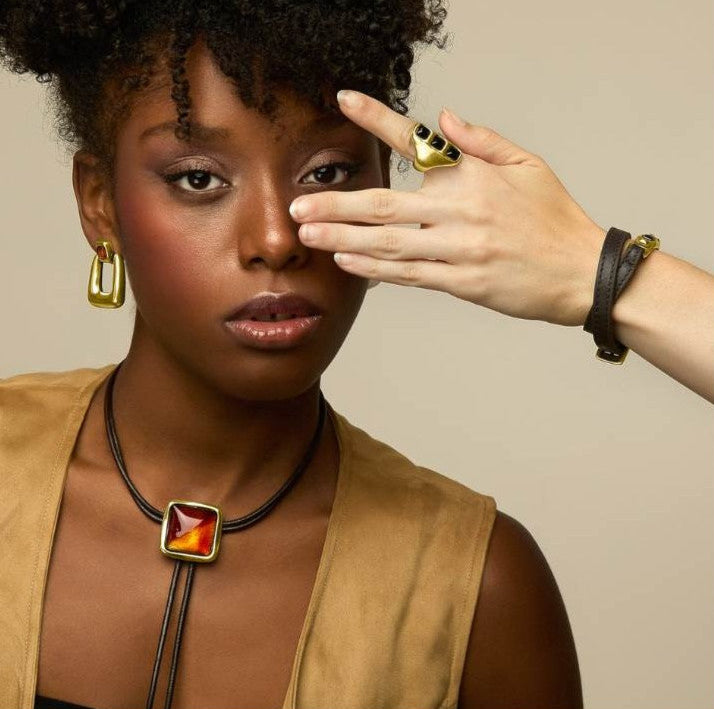 woman wearing Leather necklace with square pendant made of gold and Murano crystals 