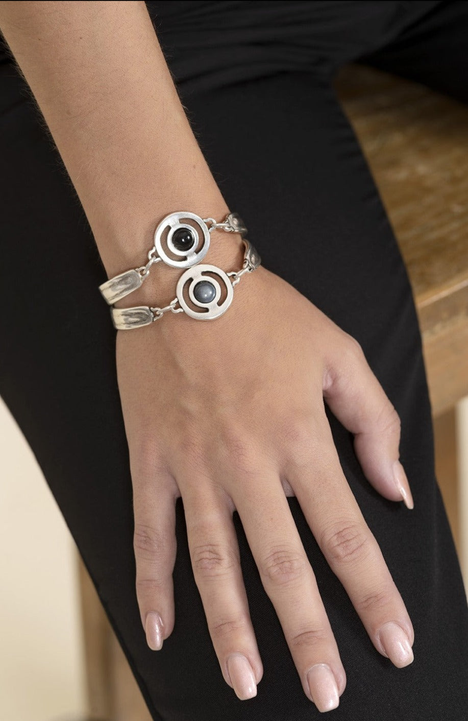 woman wearing two Semi-rigid bracelets with central motif decorated with Murano dial