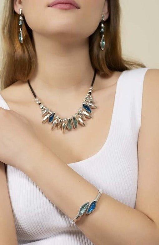 woman wearing silver bracelet with open design adorned with vibrant crystal accents