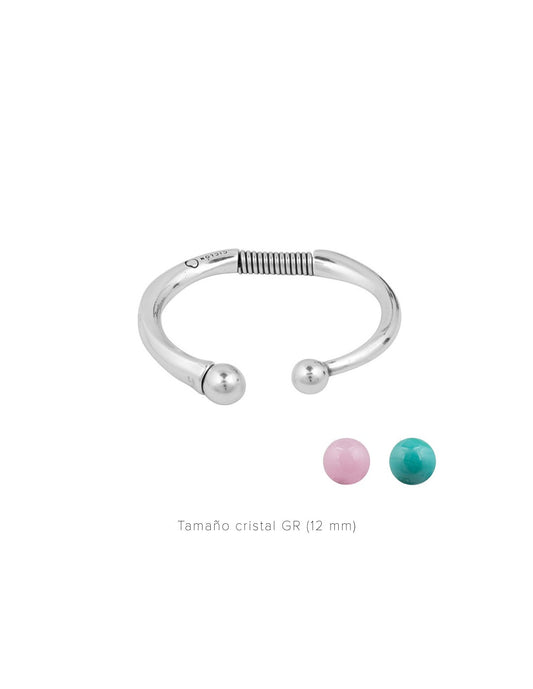  silver plated bracelet featuring a chic open design and interchangeable 12mm crystal accents in pink and turquoise