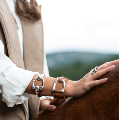 woman wearing silver bracelet with stirrup closure