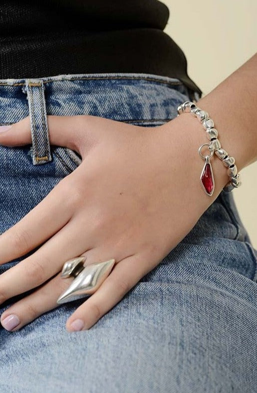 woman wearing silver stretch bracelet adorned with Murano glass