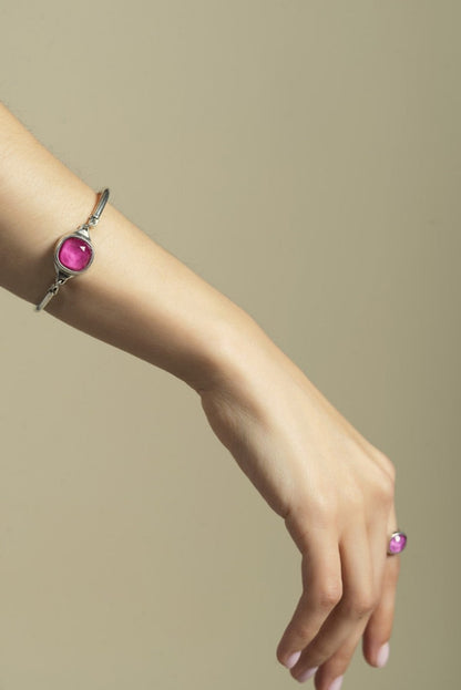 woman wearing silver bracelet with faceted rose square stone